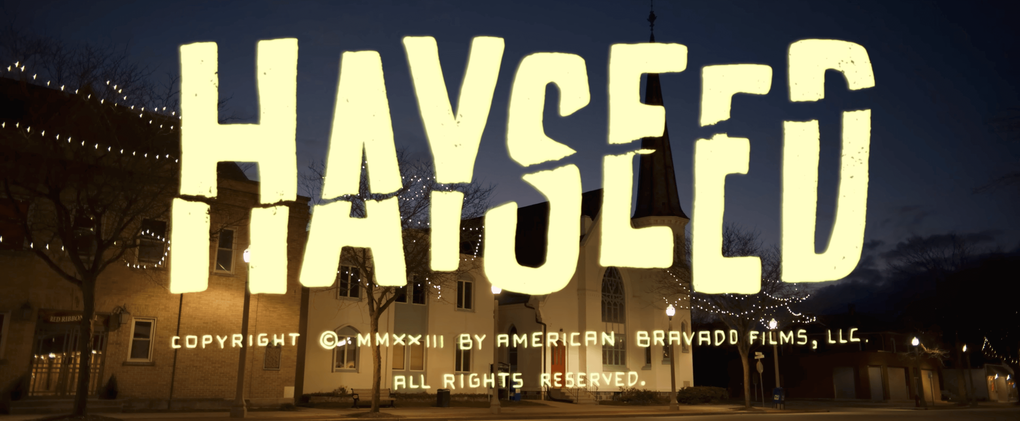 Hayseed title over a nighttime town street
